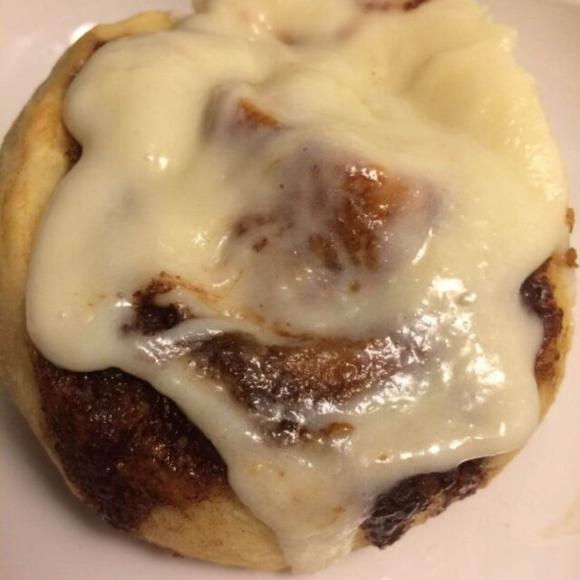 single cinnamon roll with frosting