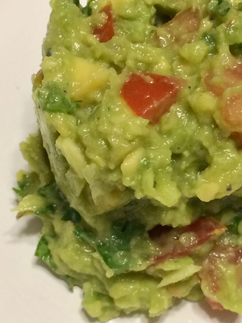 guacamole scooped onto white place offset