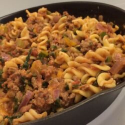 hamburger helper cooked in cast iron with image pan tilted to the left