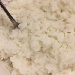 white rice with metal spoon