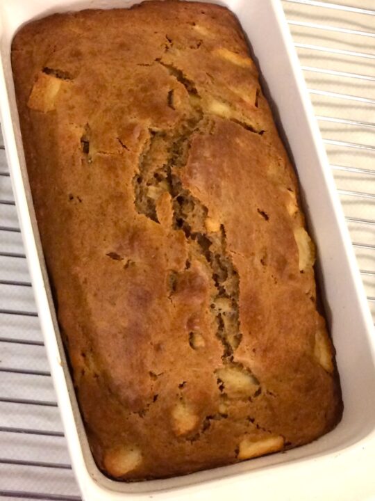 pear and apple bread in CorningWare cake pan on cooling rack