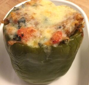 green stuffed bell pepper with melted cheese on top