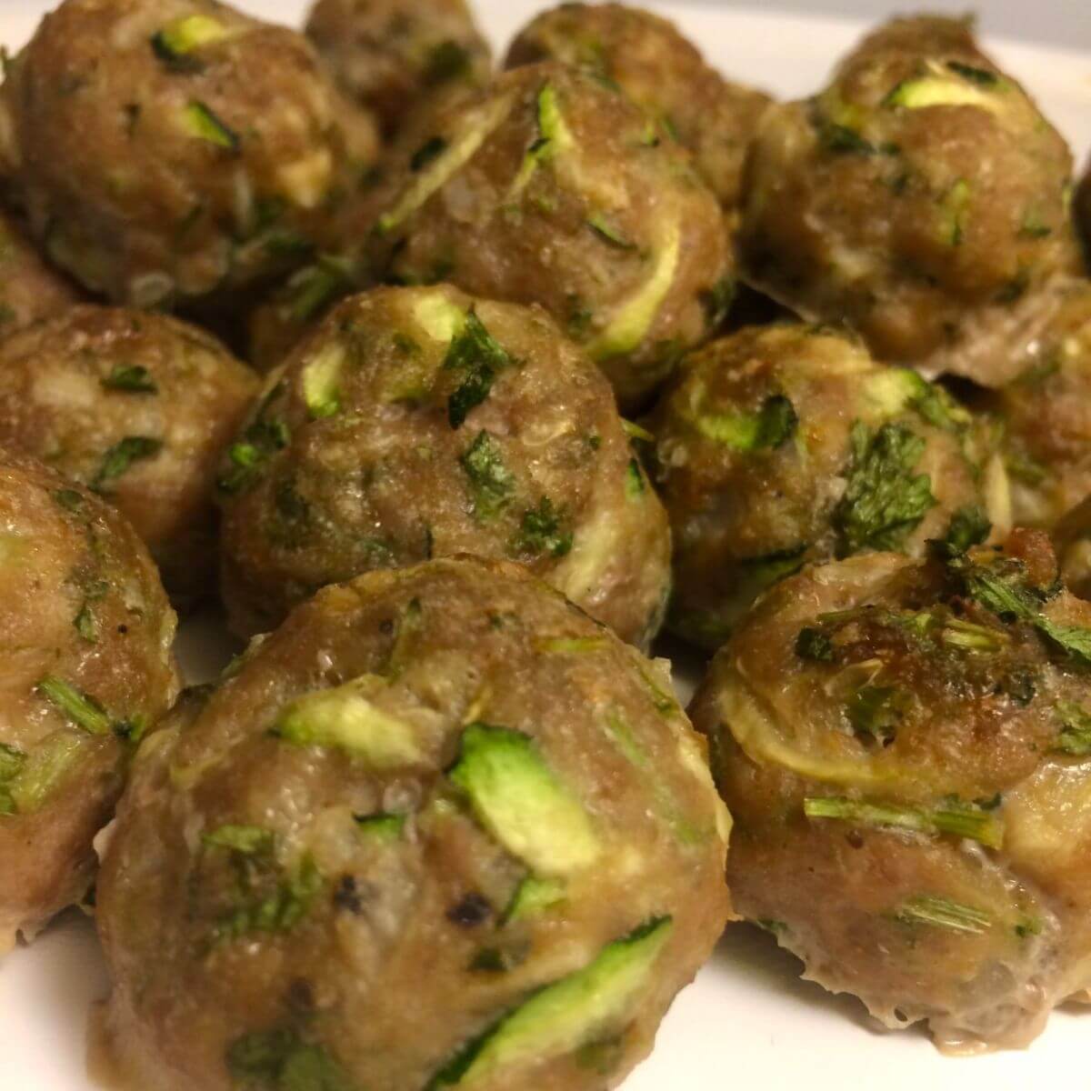 baked turkey meatballs piled on a white plate