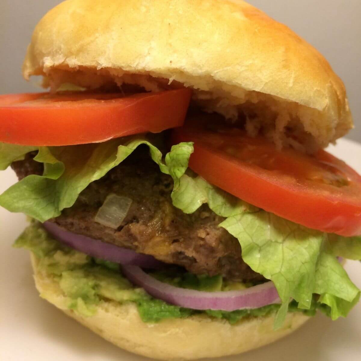 complete burger with fixings on homemade bun