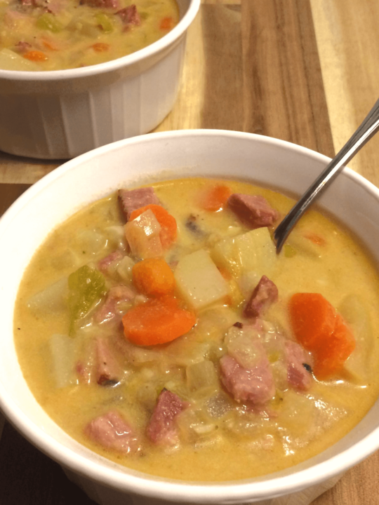 ham and potato soup in white bowl