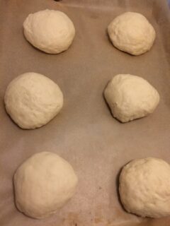 sweet roll dough portioned out and rolled into balls