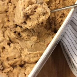 caramel walnut ice cream in bread pan with spoon scooping
