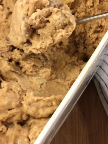 caramel walnut ice cream in bread pan with spoon scooping