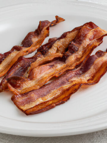 crispy bacon on a white plate
