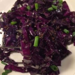 stir fried cabbage with chia with fork lifting small portion all on white plate