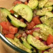 fresh cucumber tomato salad in glass bowl