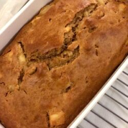 pear and apple bread in CorningWare loaf pan on cooling rack