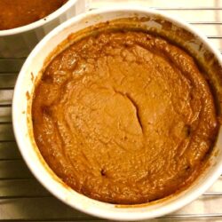 pumpkin custard in white bowl on cooling rack