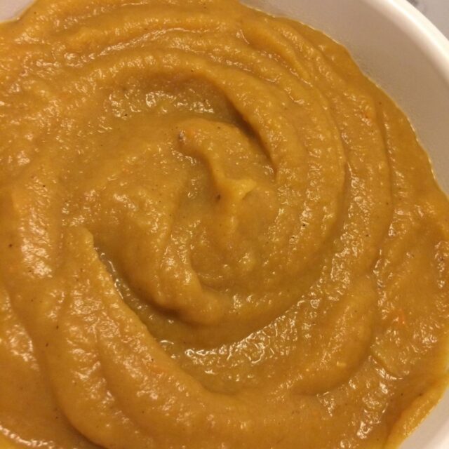 roasted acorn squash soup blended smooth in white bowl