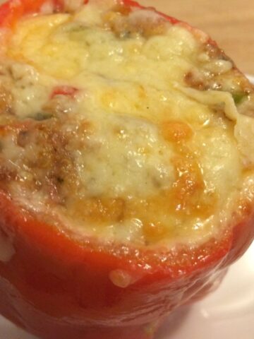 stuffed red bell pepper with melted cheese on top