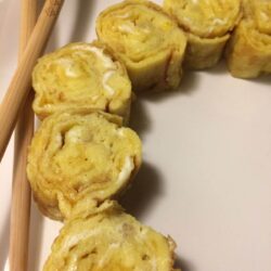 tamago rolled with chopsticks on white plate