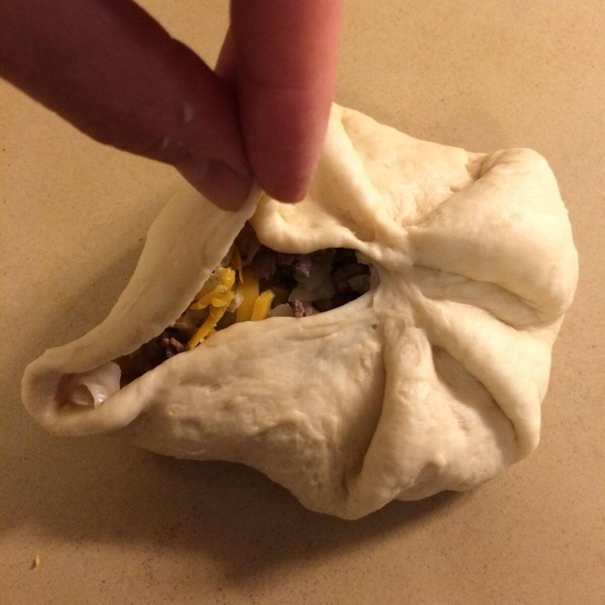 finishing the seal of the dough over the filling