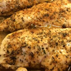 baked chicken breasts close up with spices on top