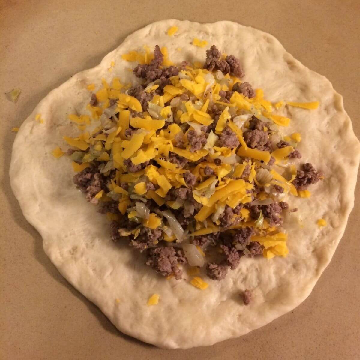 kraut burger filling placed in middle of dough portion