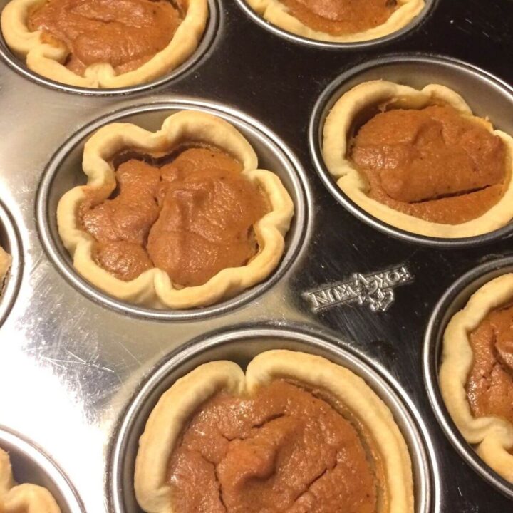 baked mini pumpkin pies in muffin tin close up