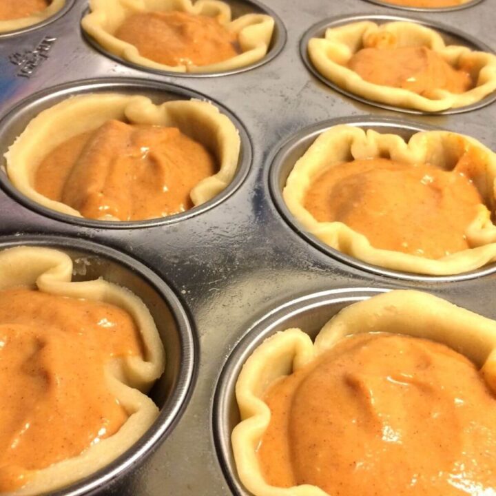 uncooked mini pumpkin pies n muffin tin close up