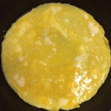 tamago egg mixture poured into cast iron skillet.