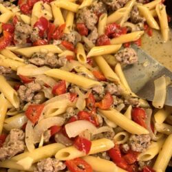 Penne pasta with ground pork, red peppers, and onoin in a light sauce.